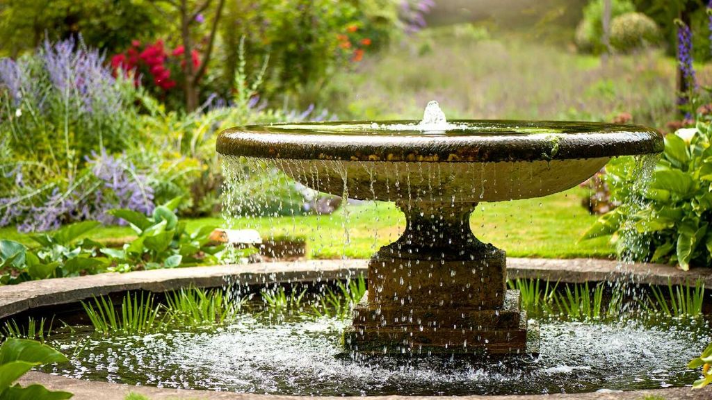 fountains and ponds are signature water features in english gardens, providing tranquility through the soothing sound of moving water.