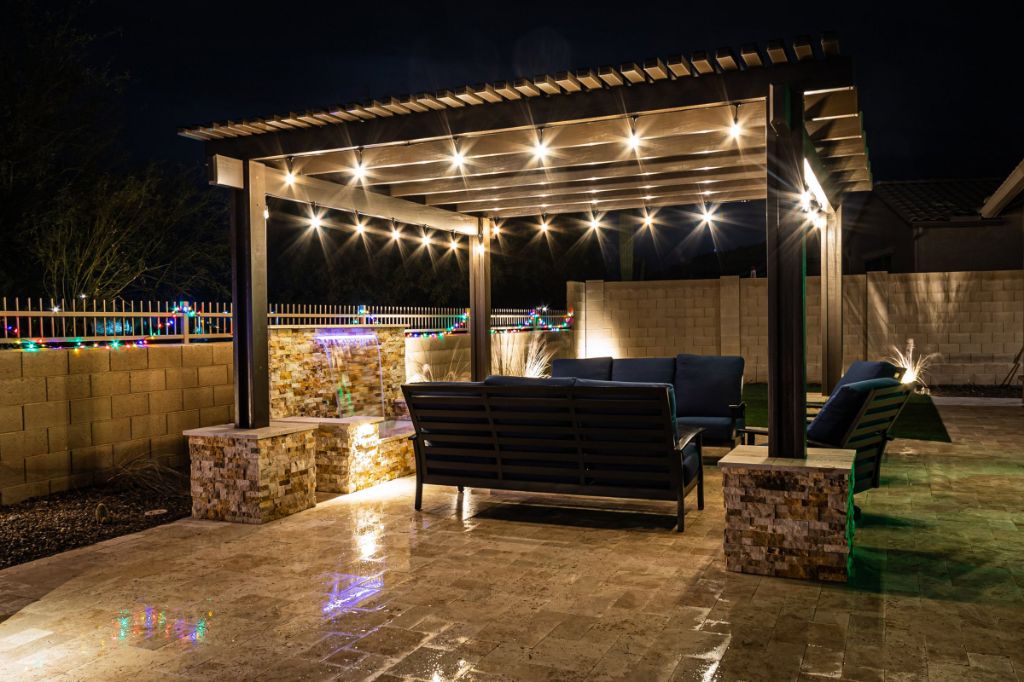 strategic lighting and plantings enhance fire pit ambiance