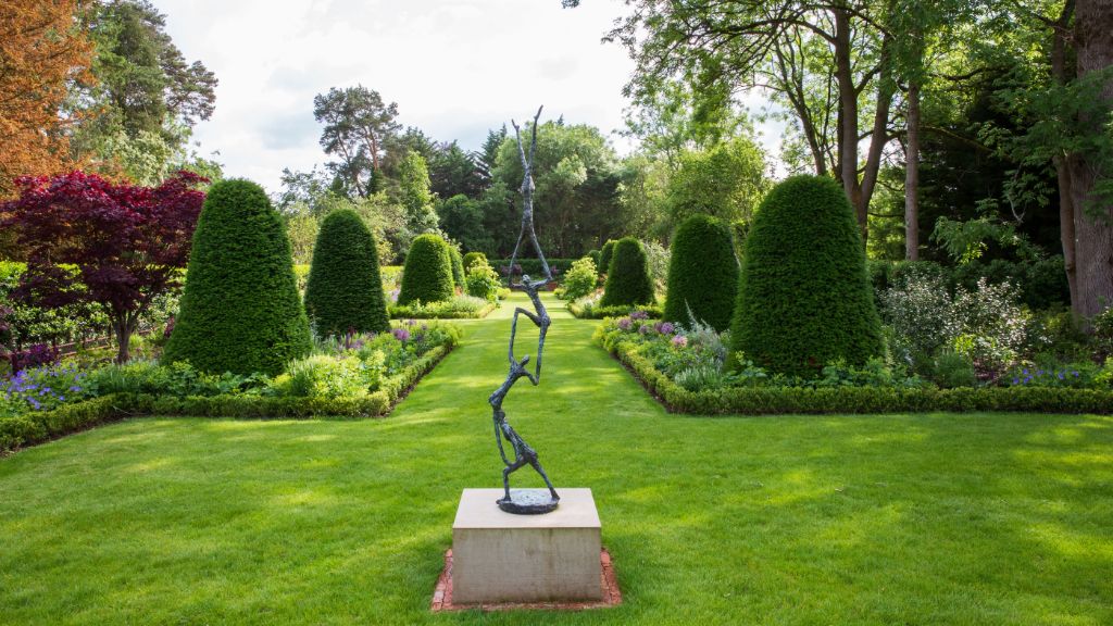 used garden sculptures add an artistic design element to landscape